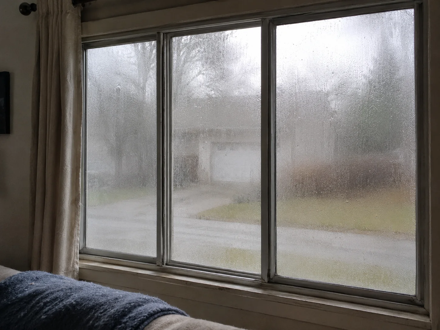 Foggy, drafty 1980s aluminum windows before replacement